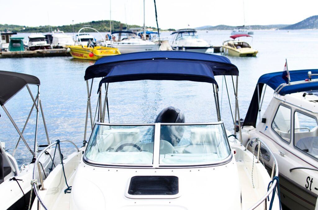 pexels photo 296236 296236 1 A serene marina scene featuring multiple boats docked on calm waters under a blue sky.